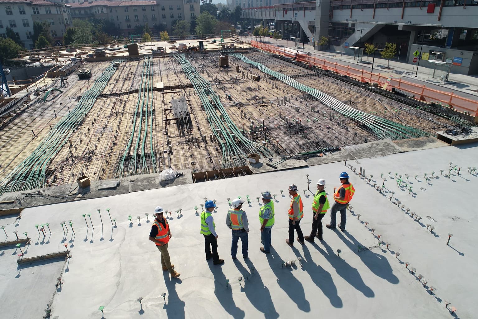 Engineers in safety gear reviewing a construction site