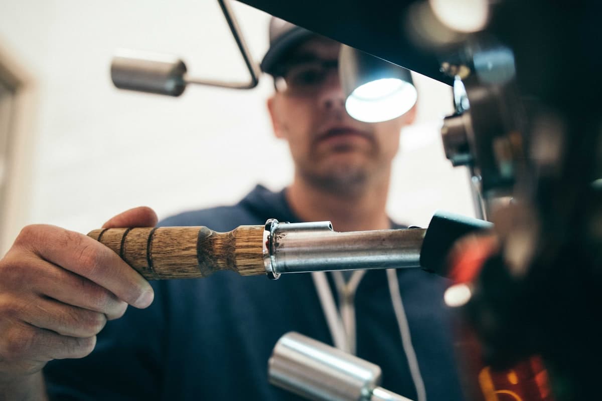 Technician inspecting industrial piping with hand tools